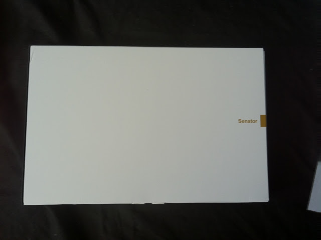 a white rectangular object with gold text
