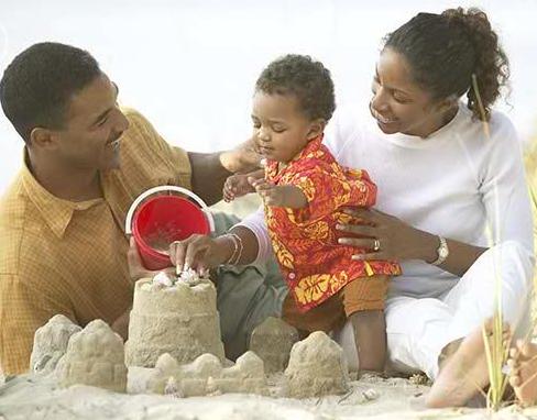 african_parents_and_toddler_building_sand_castle_bld028659.jpg