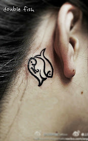 two little fish tattoo behind the ear