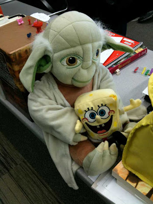 Plush Yoda doll with a smaller Spongebog doll on his lap