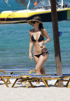 Maria Menounos at the beach in Myconos holding a drink