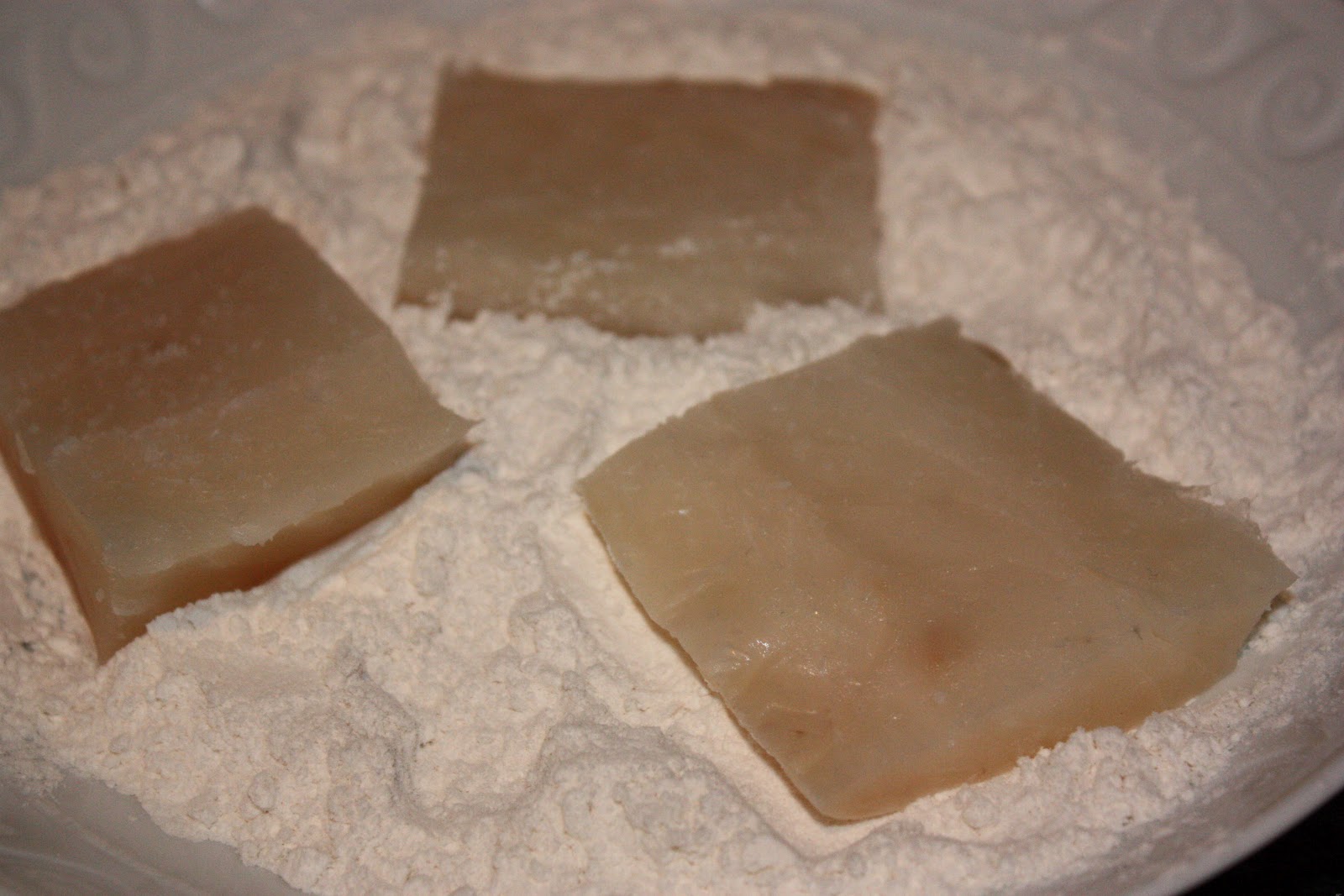 Begin by dredging the fish through the flour, coating every side and then transfer to the egg