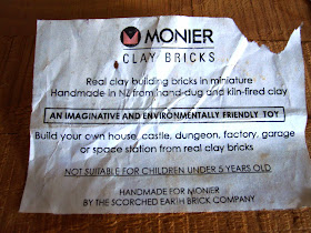 Paper label on the top of a box of miniature Monier clay bricks.