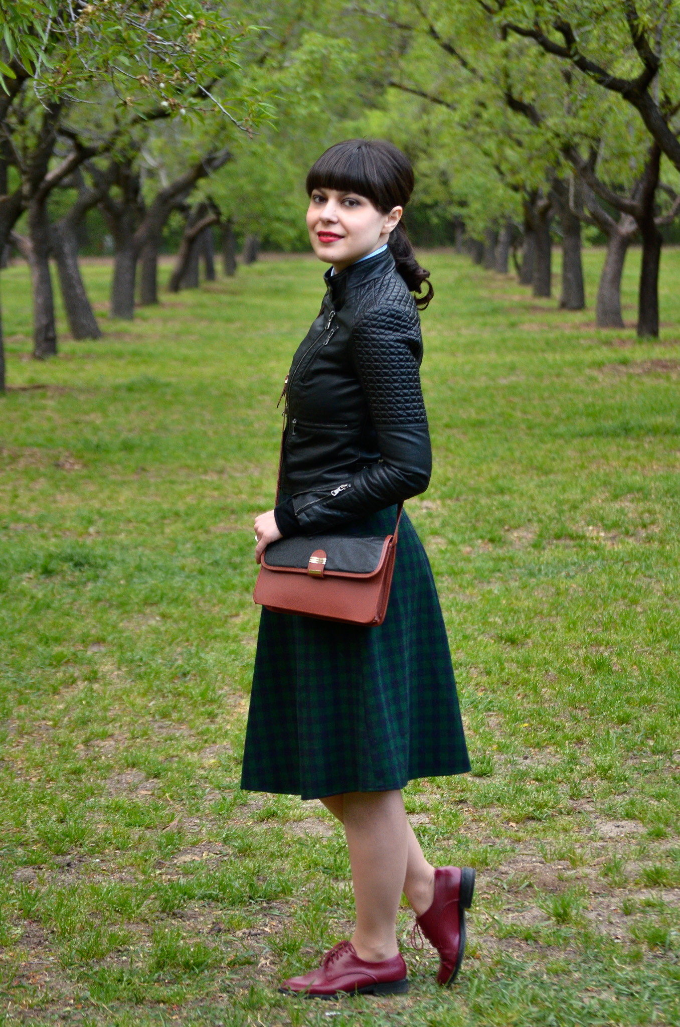 school girl outfit in madrid green tartan midi skirt thrifted brown bag satchel sky blue shirt black bow tie bangs burgundy oxford shoes poema spring green fresh park