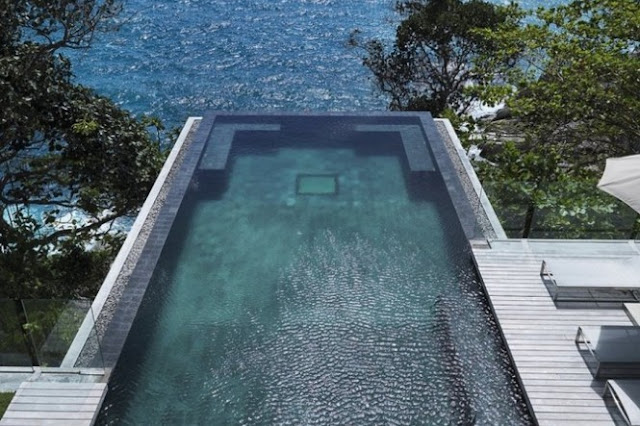 Photo of swimming pool on the edge of the cliff overlooking the ocean