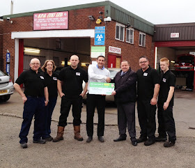 Presentation of feedback prize cheque at SPG UK Ltd garage in Cheshire