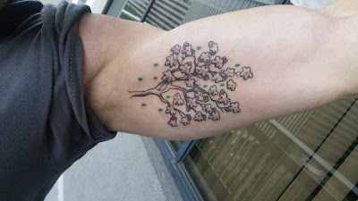 Benjamin Rubenstein's tattoo of a fig tree with green droplets of water