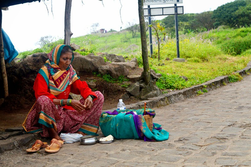 an old sales women selling testy foods women testy India