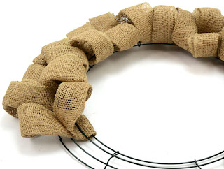 Step 5: Continue weaving the ribbon on the burlap wreath | MardiGrasOutlet.com