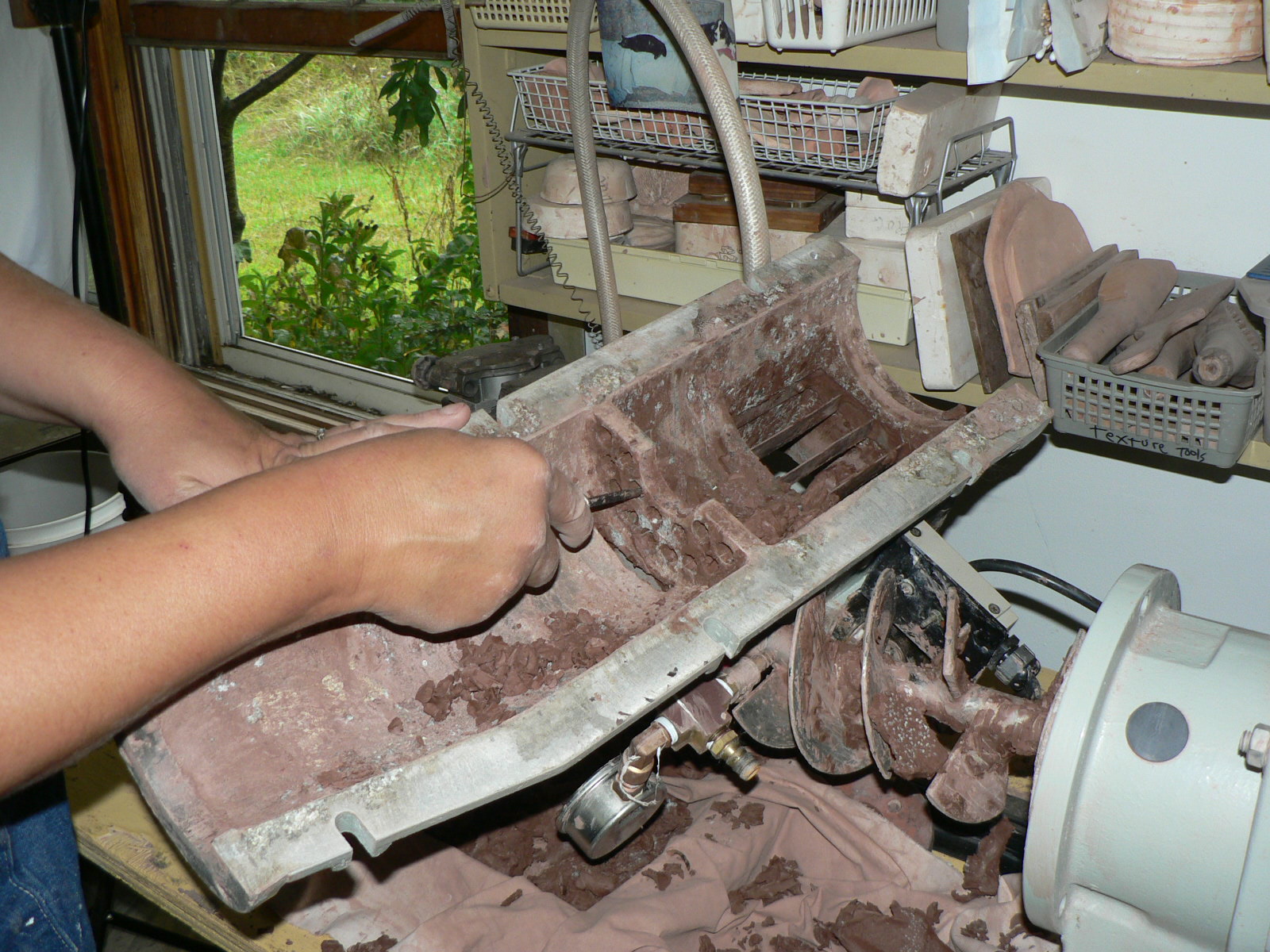 ANN TUBBS POTTERY STUDIO Cleaning out the pug mill