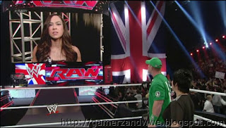 Vickie Guerrero and John Cena look at AJ on Titantron while she speaks