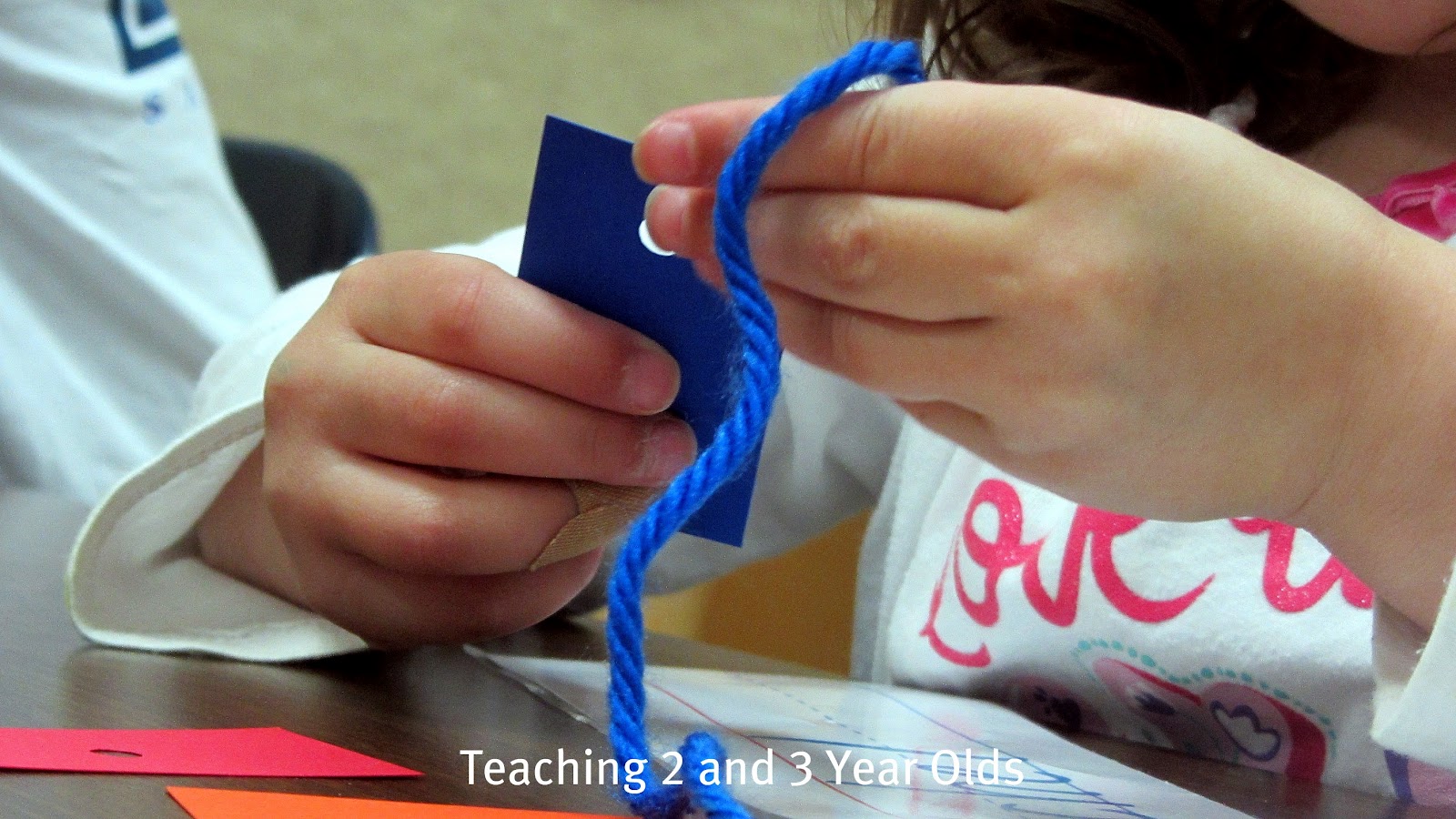 Teaching 2 and 3 Year Olds Rainbow Threading Necklaces