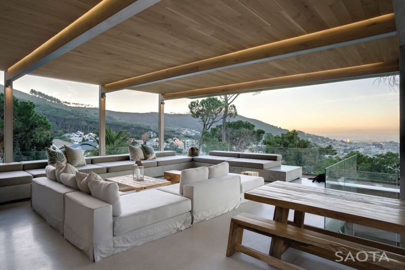 Photo of large covered terrace with outdoor sofas and other garden furniture