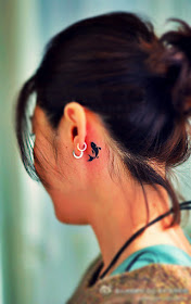 little fish totem tattoo behind the ear