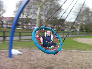 swinging on the hanging basket in the park