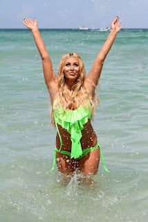AUBREY O’DAY with her arms up in the air