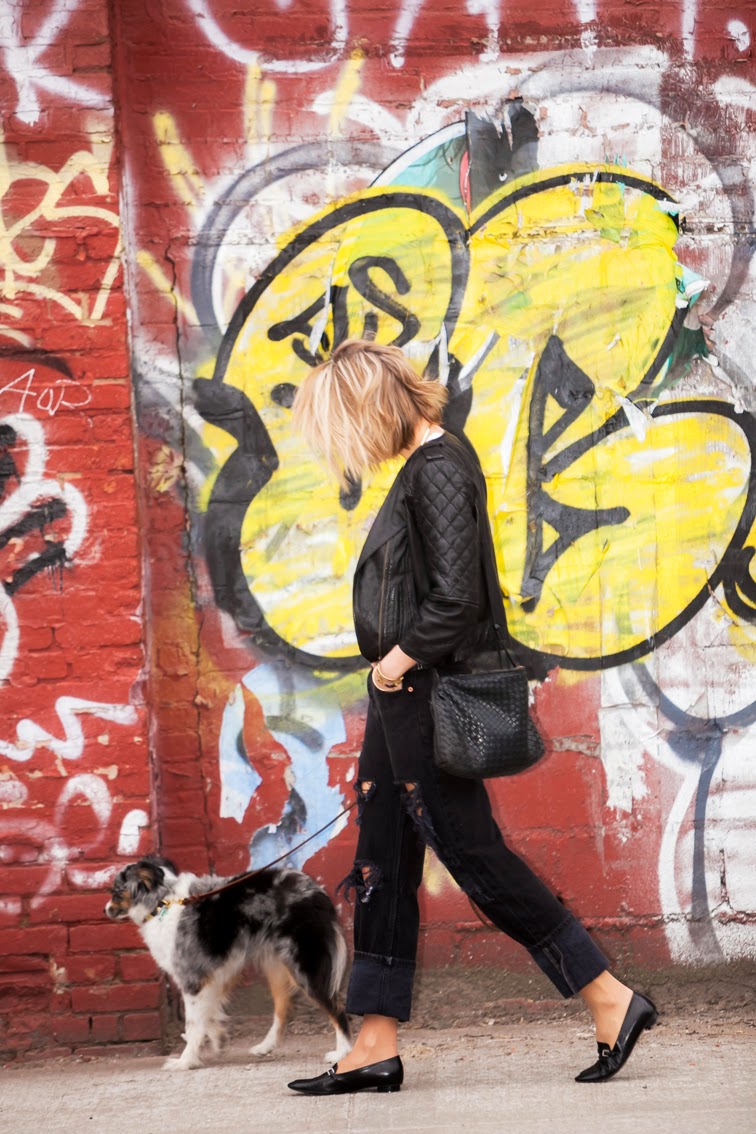 Graffiti wall, all black, quilted leather bomber jacket, Chanel loafers, Bottega Veneta intrecciato crossbody bag Graffiti wall, all black, quilted leather bomber jacket, Chanel loafers, Bottega Veneta intrecciato crossbody bag