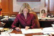 Secretary of State Deborah Bowen, signing something other than victim compensation checks