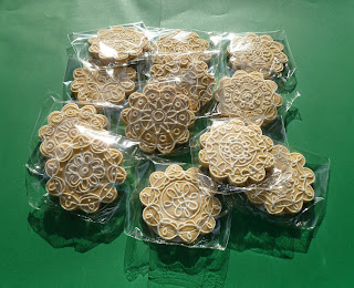 decorated lemon-rosemary tea biscuits on a true green background