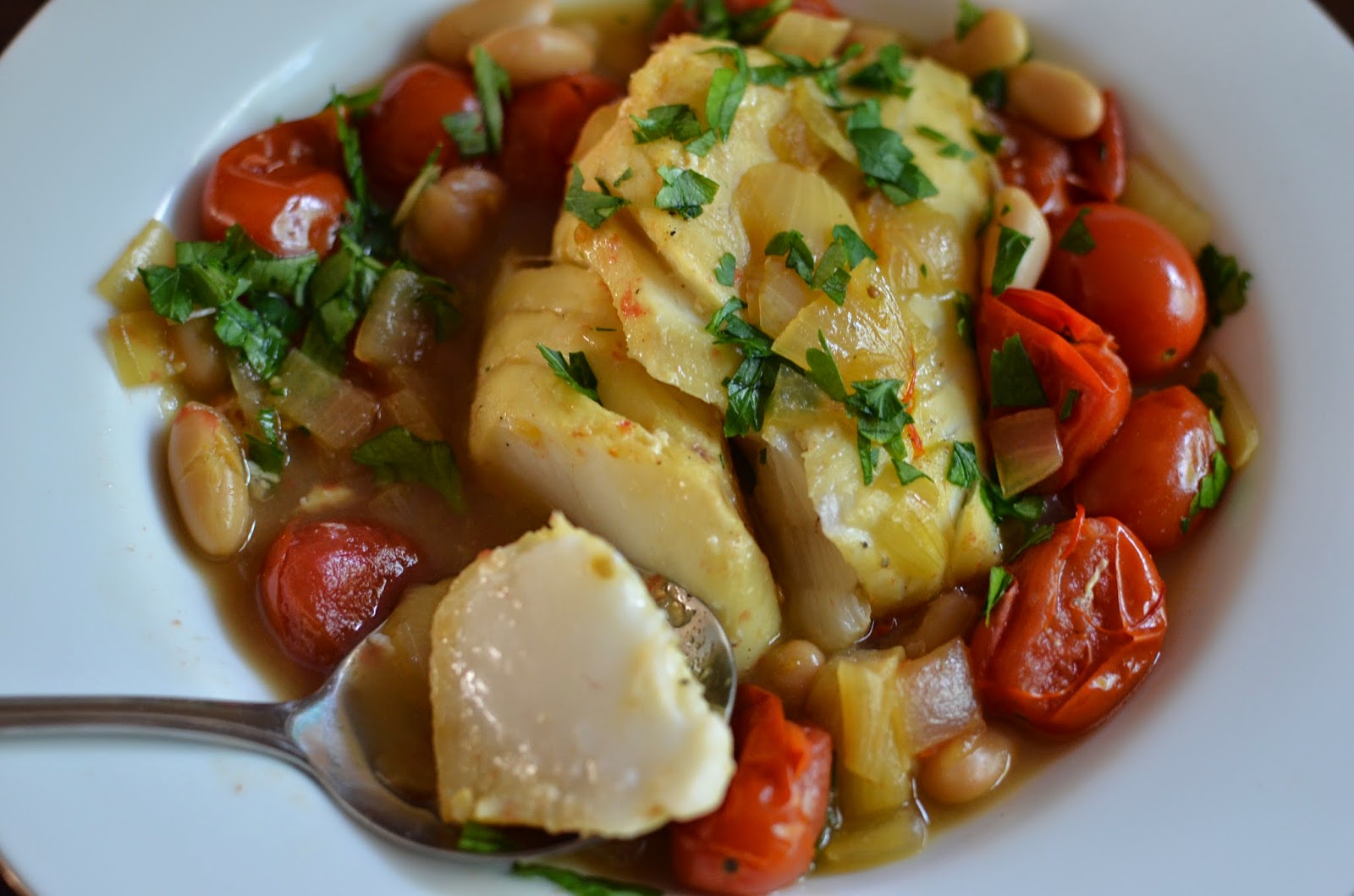 Playing with Flour Poached saffron cod with burst tomatoes and white beans