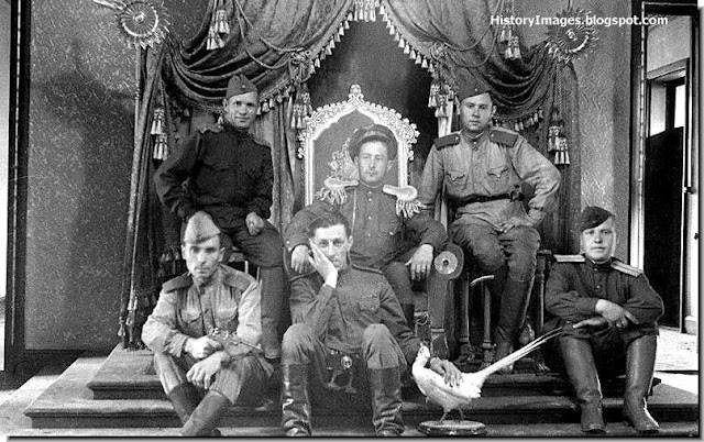 Soviet soldiers sit on the throne of the Last Chinese Emperor, Puyi. September 1945