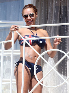 Melanie Brown posing in her Australian flag bikini on the balcony