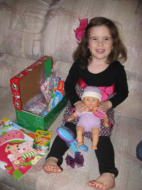 Adelaide with the pile of toys and treats for the little girl.