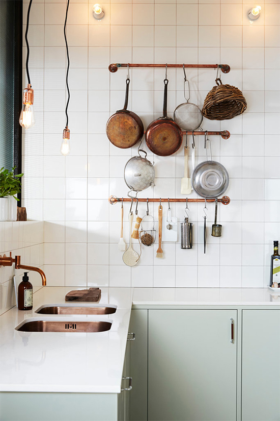 Mint cabinetry, white tiles and copper fixtures kitchen by Ballingslöv.