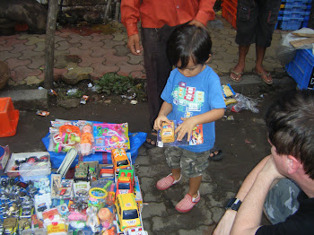 Xavier picks out a toy from the market across the street.