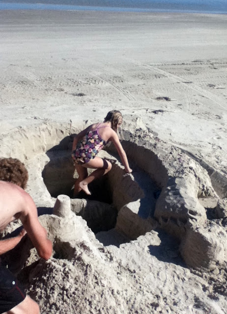 Diigging a sand castle with Daddy image