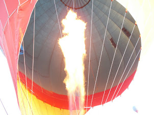 Flring the hot air balloon during flight to increase the ascent.