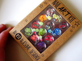 Box of nail art pices in the shape of miniature slices of fruit.