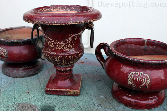 red pottery, urns, pots, flowers, planters, iron rings, weathered, chipped, chippy