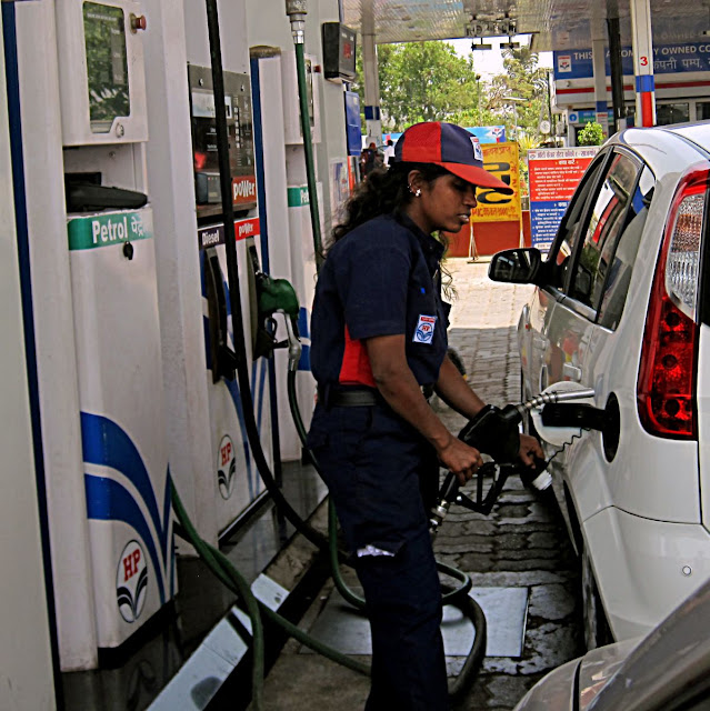 woman attendant filling gas into car