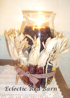 hurricane candle holder with indian corn wrapped with ribbon