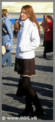 Lady in the demi-season coat on the street 