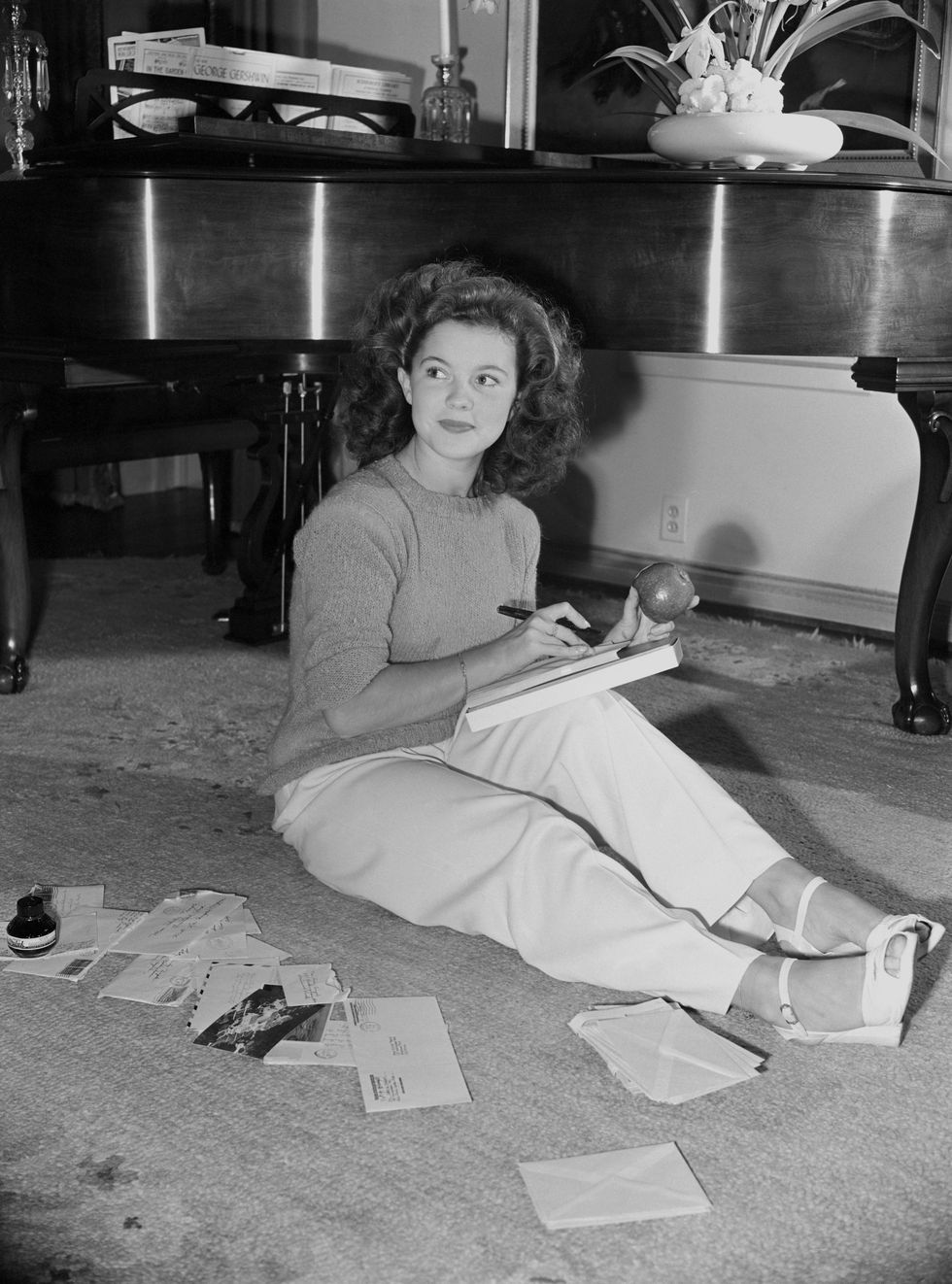 Shirley Temple answering fan mail at her Los Angeles home in 1944