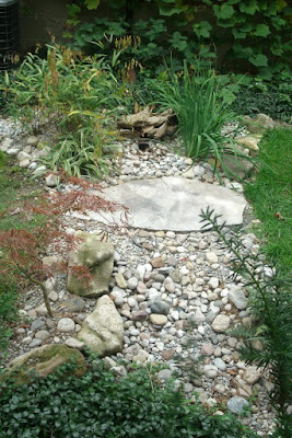 Dry stream bed with river rock, boulders and flagstone bridge by garden muses: a Toronto gardening blog 
