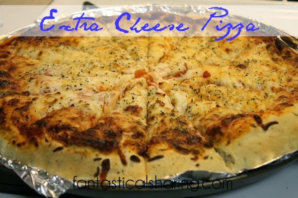 Extra Cheese Pizza | Check out this pizza topped with tons of cheese and a hint of basil! #homemade #pizza #cheese
