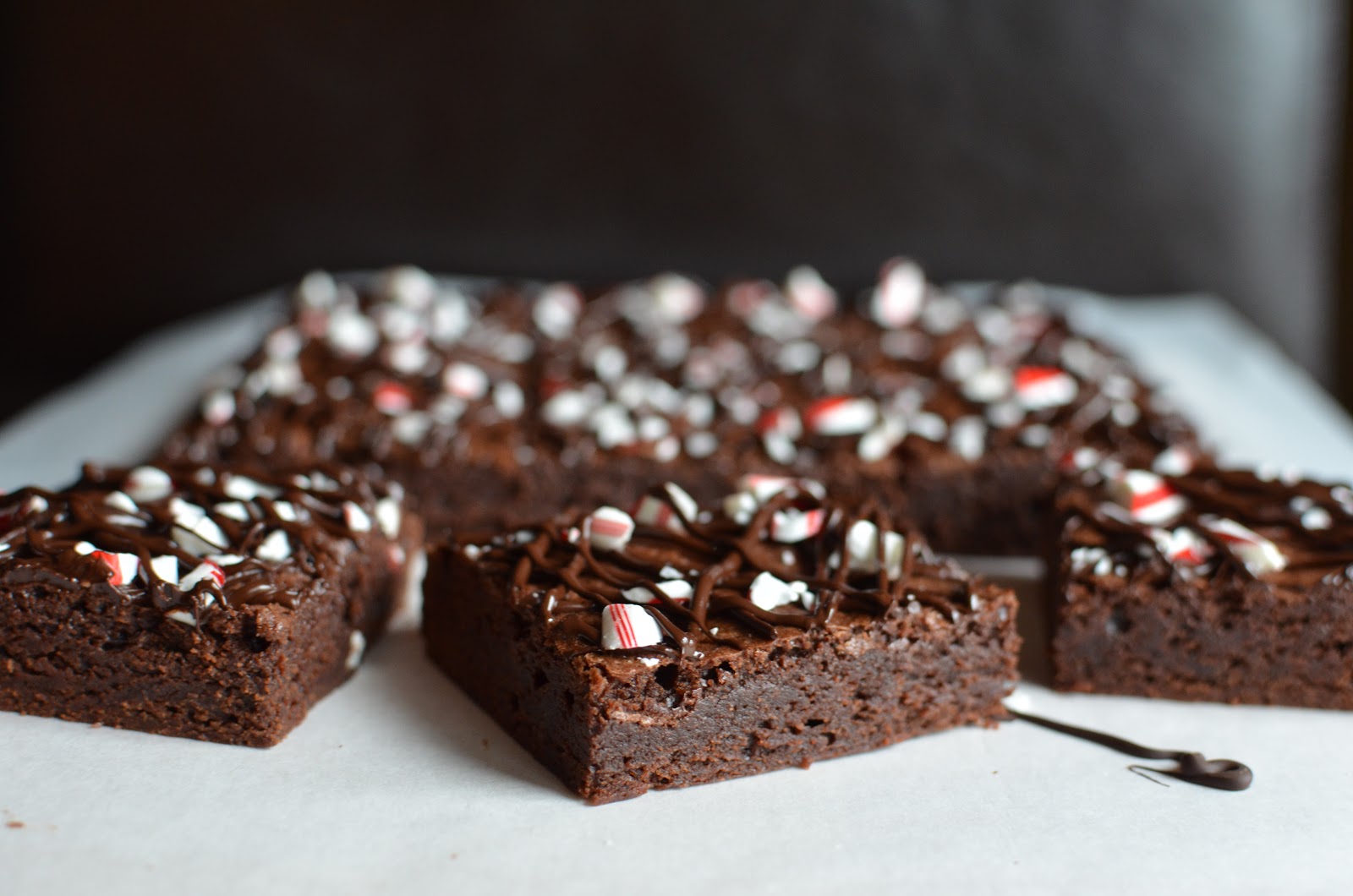 Playing with Flour Peppermint brownies topped with candy cane and dark
