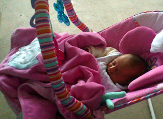 tiny baby in bouncy chair