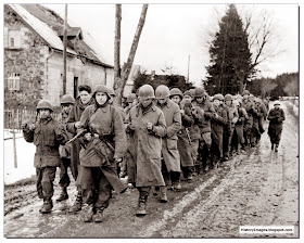 American POW walking through Belgian village December 1944