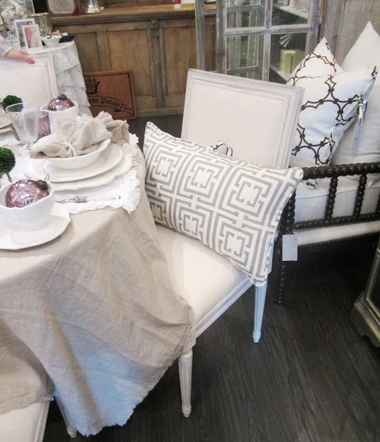 Nbaynadamas Logo pillow in grey on a dining chair at PomPom Interiors