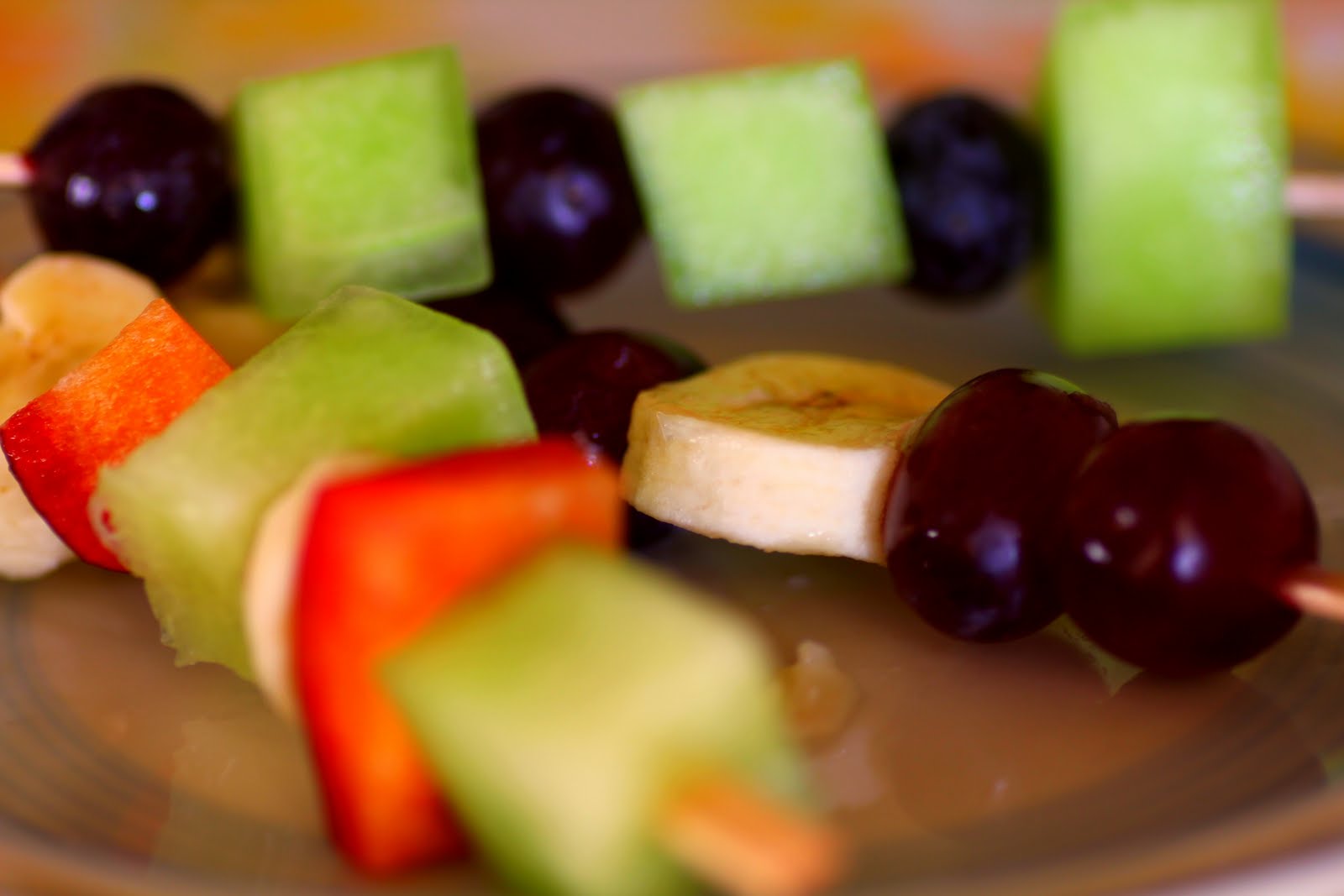 a happy wanderer patterned fruit kabobs...