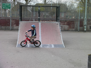 riding a bicycle on skateboard ramp in park