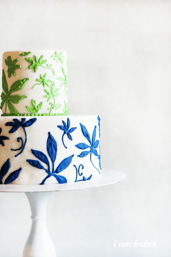 A two tier white green and blue wedding cake with botanical print created 