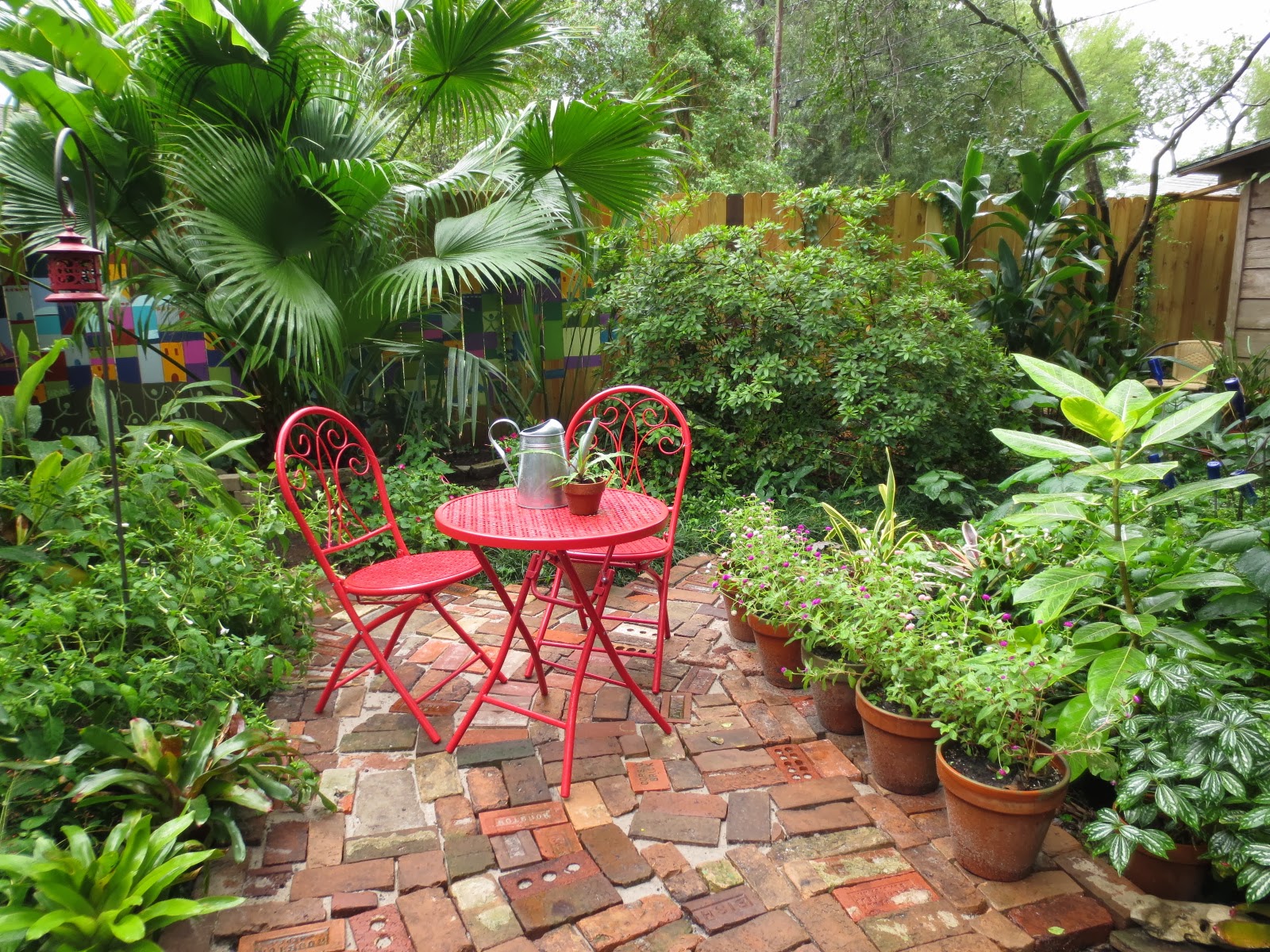 Tropical Texana ANTIQUE BRICK COURTYARD COMES TO LIFE HERE IN THE GARDEN