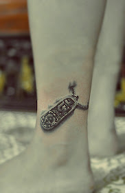 A shining dog tag tattoo on the ankle