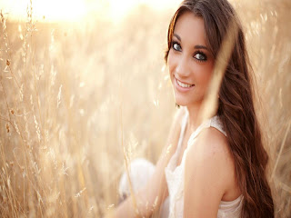 Cute girl smiling in fields of wheat image