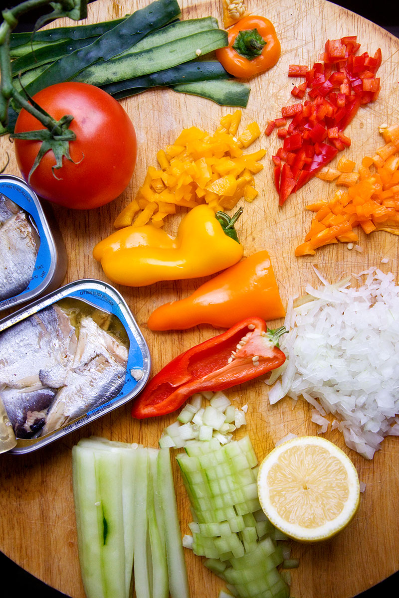 Drain water or oil from sardines. Finely chop tomatoes, bell peppers